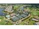 Aerial view of community with golf course, tennis courts, pool, and clubhouse at 1062 Eagles Flight Way, North Port, FL 34287