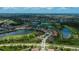 Beautiful aerial view of property in a community with lakes, golf course, and lush landscaping at 1062 Eagles Flight Way, North Port, FL 34287