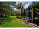 Expansive backyard featuring a screened-in pool and lush landscaping at 1062 Eagles Flight Way, North Port, FL 34287