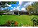 Spacious backyard with lush green lawn and screened lanai at 1062 Eagles Flight Way, North Port, FL 34287