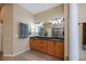 Elegant bathroom featuring a double vanity with granite countertops and warm-toned cabinetry, complemented by neutral wall colors at 1062 Eagles Flight Way, North Port, FL 34287