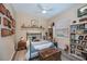 Cozy bedroom with a wrought iron bed frame, a ceiling fan, and built-in shelving, offering a comfortable and stylish retreat at 1062 Eagles Flight Way, North Port, FL 34287