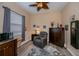 Bedroom with sitting area, ceiling fan, and window at 1062 Eagles Flight Way, North Port, FL 34287