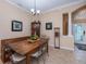 Charming dining area with a rustic wood table, unique decor, and neutral-toned walls at 1062 Eagles Flight Way, North Port, FL 34287