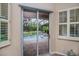 Sliding glass doors lead to a screened-in lanai and a swimming pool at 1062 Eagles Flight Way, North Port, FL 34287