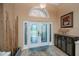 Inviting foyer with beautiful glass double doors, tile flooring, and decorative accents at 1062 Eagles Flight Way, North Port, FL 34287