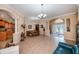 Open-concept entryway with tile flooring, arched doorways, and a view into the kitchen and dining areas at 1062 Eagles Flight Way, North Port, FL 34287