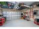 Organized garage with epoxy floors, overhead storage racks and wall-mounted tool organizers at 1062 Eagles Flight Way, North Port, FL 34287