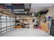 Spacious garage with epoxy flooring, overhead storage racks, and organization system at 1062 Eagles Flight Way, North Port, FL 34287
