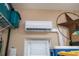 A mini split air conditioner is mounted to a wall above a window at 1062 Eagles Flight Way, North Port, FL 34287