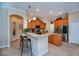 Modern kitchen featuring a breakfast bar, granite countertops, stainless steel appliances, and ample cabinet space at 1062 Eagles Flight Way, North Port, FL 34287