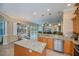 Open-concept kitchen with a view of the dining area, pool, and living area with lots of natural light at 1062 Eagles Flight Way, North Port, FL 34287