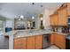 Well-appointed kitchen with granite countertops, stainless steel appliances, and backyard views at 1062 Eagles Flight Way, North Port, FL 34287