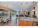 Bright kitchen featuring granite countertops, modern lighting, and seamless access to the outdoor pool area at 1062 Eagles Flight Way, North Port, FL 34287