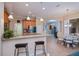 Open kitchen boasts granite countertops, breakfast bar, and stainless steel appliances, perfect for entertaining guests at 1062 Eagles Flight Way, North Port, FL 34287