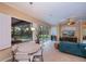 Open-concept living room features a dining area and sliding glass doors to the outdoor pool area at 1062 Eagles Flight Way, North Port, FL 34287