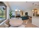 Bright living space with views of the pool, neutral walls, and access to the kitchen at 1062 Eagles Flight Way, North Port, FL 34287