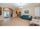 Open-concept living area with tile flooring, neutral paint, and an archway entrance to the front foyer and dining area at 1062 Eagles Flight Way, North Port, FL 34287