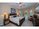 Carpeted bedroom features a ceiling fan and sliding glass doors to the pool at 1062 Eagles Flight Way, North Port, FL 34287