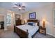 Comfortable main bedroom with carpet floors and furnishings, including bedside lamps and artwork at 1062 Eagles Flight Way, North Port, FL 34287