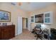 Bright office space featuring a desk, office chair, and a view of the lanai at 1062 Eagles Flight Way, North Port, FL 34287