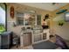 Outdoor kitchen with built-in grill and mini-fridge on a covered lanai space at 1062 Eagles Flight Way, North Port, FL 34287