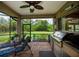 Outdoor kitchen with built-in grill, sink, and storage, next to sunbathing chairs at 1062 Eagles Flight Way, North Port, FL 34287