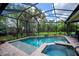 Beautiful screened-in pool and spa with lush landscaping offers the perfect outdoor oasis at 1062 Eagles Flight Way, North Port, FL 34287