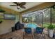 Screened pool area with a covered lanai, complete with seating and an outdoor kitchen at 1062 Eagles Flight Way, North Port, FL 34287