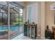 Wet bar features wine cooler, shuttered window and sliding glass doors to the covered pool area at 1062 Eagles Flight Way, North Port, FL 34287