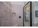 Tiled walk-in shower with a built-in niche, bench, and glass door in a neutral colored bathroom at 1062 Eagles Flight Way, North Port, FL 34287