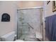 Bathroom featuring a walk-in shower with a built-in seat and grab bar for added safety at 1062 Eagles Flight Way, North Port, FL 34287