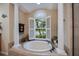 Bathroom features a round soaking tub with shuttered window at 1062 Eagles Flight Way, North Port, FL 34287
