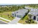 An aerial view features a single-story home with well-kept lawn and paved driveway in a residential area at 11088 Pinot Dr, Venice, FL 34293