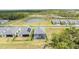 Aerial view showing several residences with a pond and trees, in a peaceful, planned community at 11088 Pinot Dr, Venice, FL 34293