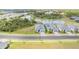 Aerial view of modern homes near a pond and lush greenery in a well-planned community at 11088 Pinot Dr, Venice, FL 34293