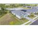 A drone shot of single-story homes, featuring a landscaped yard and water feature in the background at 11088 Pinot Dr, Venice, FL 34293