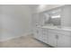 Bathroom features a double sink vanity with modern fixtures and a tiled shower visible in the mirror at 11088 Pinot Dr, Venice, FL 34293