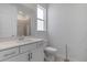 Well-lit bathroom with a shower-tub combo, white vanity, and a large bright window at 11088 Pinot Dr, Venice, FL 34293