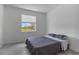 A simple bedroom features a bed, window, and tile flooring for easy maintenance at 11088 Pinot Dr, Venice, FL 34293