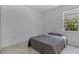 Bright bedroom features neutral walls, a cozy grey comforter, and a bright window at 11088 Pinot Dr, Venice, FL 34293
