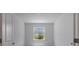 Minimalist bedroom featuring neutral walls and flooring, bright natural light from the window at 11088 Pinot Dr, Venice, FL 34293
