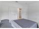 Bright bedroom featuring neutral walls, a cozy grey comforter, and two convenient closet doors at 11088 Pinot Dr, Venice, FL 34293