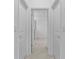 Hallway between two rooms with neutral tile flooring and white walls at 11088 Pinot Dr, Venice, FL 34293