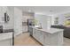 Open concept kitchen with stainless steel appliances, large island, and adjacent living space at 11088 Pinot Dr, Venice, FL 34293
