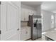 Bright kitchen area with stainless steel refrigerator, white cabinets, and quartz countertops at 11088 Pinot Dr, Venice, FL 34293