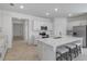 Open kitchen features a large island with seating, stainless steel appliances, and white cabinetry at 11088 Pinot Dr, Venice, FL 34293