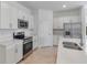 Modern kitchen featuring stainless steel appliances, quartz countertops, and white cabinetry at 11088 Pinot Dr, Venice, FL 34293