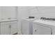 A well-equipped laundry room with a sink, countertop, overhead rack, washer, and dryer at 11088 Pinot Dr, Venice, FL 34293
