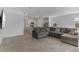 Open-concept living room with a sectional sofa, TV, and view to the kitchen, ideal for modern living at 11088 Pinot Dr, Venice, FL 34293